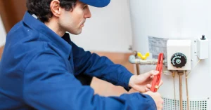 Professional technician servicing heat pump water heater explaining the technology and energy saving benefits