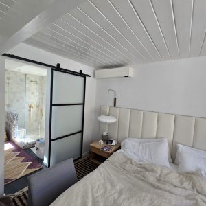 Quilt wall unit installed in a bedroom providing heating and cooling for this Eichler home in Lucas Valley