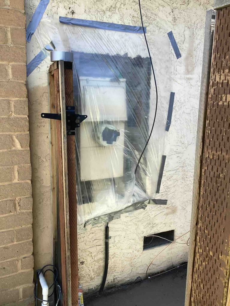 The new Siemens 200-amp panel wrapped and protected mid-installation. Every Bellows project includes home protection measures throughout the job.