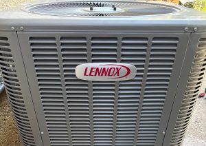 HVAC technician inspecting air conditioner unit at San Jose home in summer