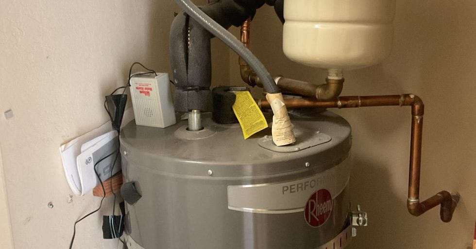 Bellows technician installing a heat pump water heater in a Bay Area garage ahead of the zero-NOx rule deadline
